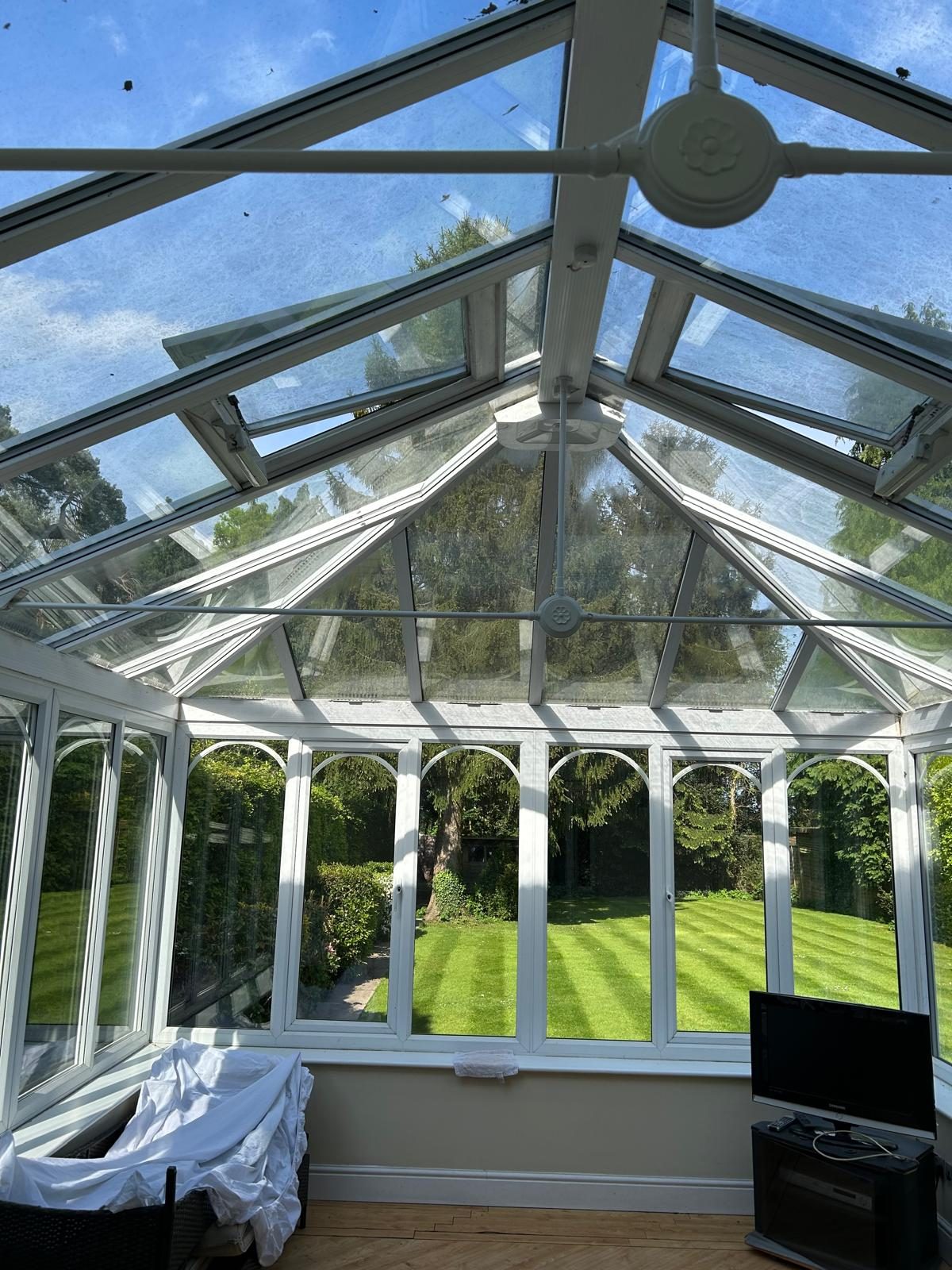 Conservatory glass roof and glazing bars cleaned inside and out, letting daylight back into the room