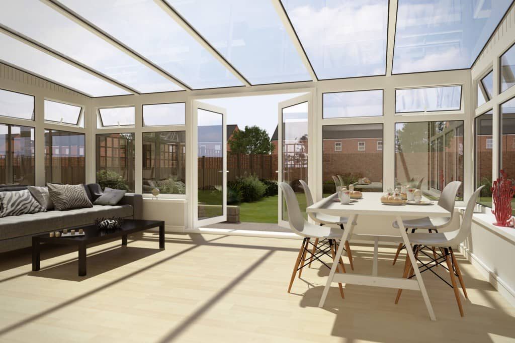 Bright, freshly cleaned conservatory with clear roof glazing and spotless white frames